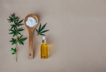 Obraz na płótnie Canvas Glass bottle and dropper CBD OIL, THC tincture and cannabis leafs on pastel background. Laboratory Production of cosmetics with CBD oil. Top view