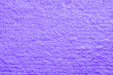 Abstract violet background. Rough irregularities in the plaster. Wall surface.