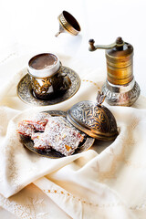 Traditional turkish dessert cezerye and Turkish coffee with coffee grinder. Festival of sacrifices. Feast of Ramadan. Cezerye is made with boiled carrots, sugar, pistachio and coconut. 