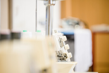 Seamstress crocheting wool close-up. Handmade and hobbies. A knitter is sewing a yellow knitted toy.