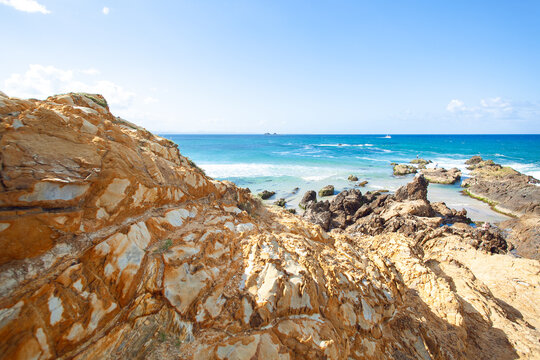 Amazing coast line called Painted Cliffs with orange yellow colored sand limestone rocks and geology structures at shore. Australia - Powered by Adobe