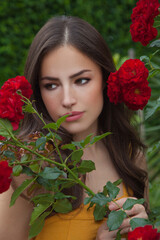 pretty young woman in rose garden - 367527816