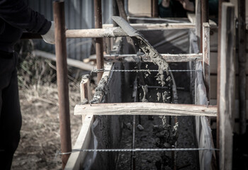 Fototapeta premium Pouring concrete into the foundation at a construction site.