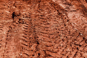 Traces of a truck on red soil.