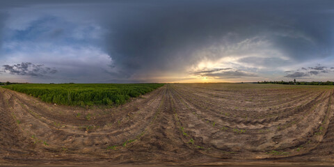 full spherical hdri panorama 360 degrees angle view among fields in summer evening sunset with beautiful clouds before storm in equirectangular projection, ready for VR AR virtual reality