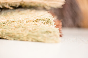 hands of the elderly craftsman while weaving a wicker basket at the market