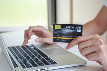 Online payment,Man's hands holding a credit card and using smart phone for online shopping