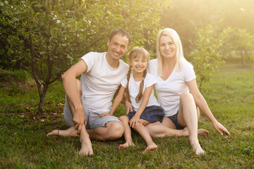 Fototapeta premium Portrait of cheerful extended family sitting in the park