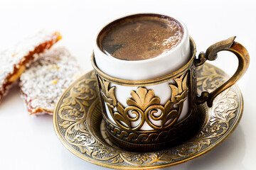 Turkish coffee with traditional turkish dessert cezerye and copper serving set. Feast of Ramadan. Cezerye is made with boiled carrots, sugar, pistachio and coconut. It is located dessert of Mersin.