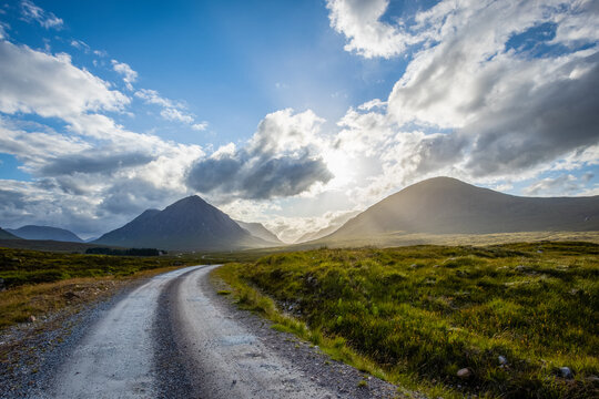 a lonely road heading towards the valley of glencoe in the argyll region of the highlands of scotland in summer