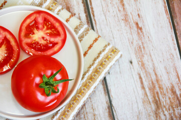 natural red tomato with green a leaves