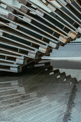 Wooden pallets and reflection in the puddle. Image with selective focus and noise effect.
