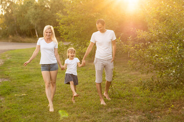 happy young family spending time outdoor on a summer day