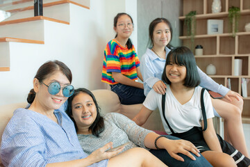 asian woman and teenager smiling with happiness in home living room