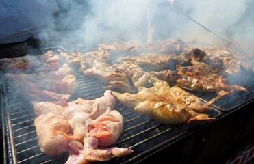 Whole grilled chicken on charcoal during Madeira Carnival (Festa dos Compadros)