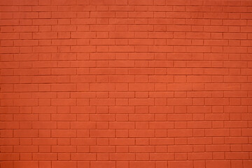 brick wall of bricks painted with bright red paint as the background