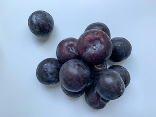 Dark, fresh plum on a white background. Harvest. vitamins, healthy food.