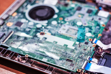 Obraz premium Computer circuit board. Computer repair shop. High technology. Motherboard. Laptop motherboard. Cooler