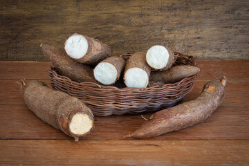 Fresh Cassava root on a wooden background. Copy space.