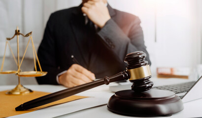 Business and lawyers discussing contract papers with brass scale on desk in office. Law, legal services, advice, justice and law concept picture with film grain effect