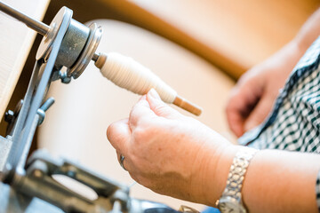 Close up of gold silk weaving on loom, cotton on the manual wood loom in Asian traditional culture and woman hand weave lifestyle
