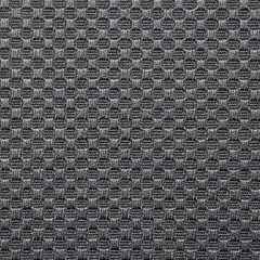 The texture of a dense fabric embroidered in a checkerboard pattern.