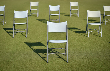 Chairs on the turf of a soccer field maintaining the social distance imposed by corona virus...