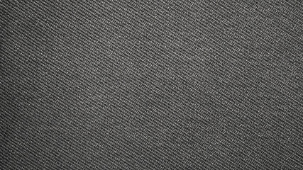 The texture of dark gray fabric is fluted in stripes.Background of dense gray fabric.