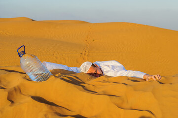 Portrait of thirsty Arabic man on a middle of yellow desert.