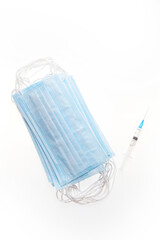 Medical mask and syringe isolated on a white background