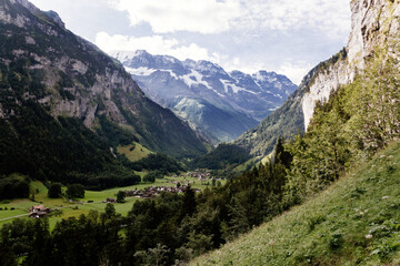 Fototapeta na wymiar Scenic view on green mountings and sky in Lauterbrunnen Valley, Switzerland