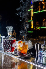 Bartender prepair cocktail in american bar. Classic smoked negroni cocktail