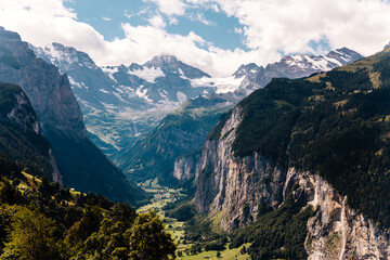 Scenic view on green mountings and sky in Lauterbrunnen Valley, Switzerland