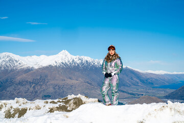 Fototapeta na wymiar Beautiful asian woman enjoying and relaxing view with snow flake on snow mountain during winter in New Zealand.