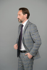 Fototapeta premium Reaching Your Goal. Bearded man in formalwear grey background. Businessman has beard. Hair salon and barbershop. Business casual style. Giving man confidence. Senior employee grey background