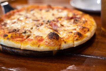 Close up pizza on woodden plate.