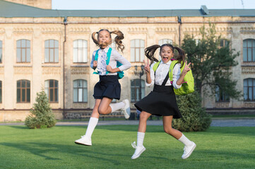 Fototapeta premium Excited school kids formal uniform running, hurry up concept