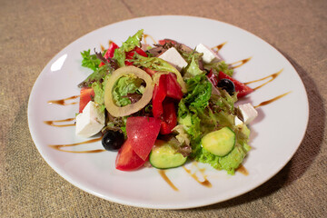 Delicious and healthy Greek salad on a white plate