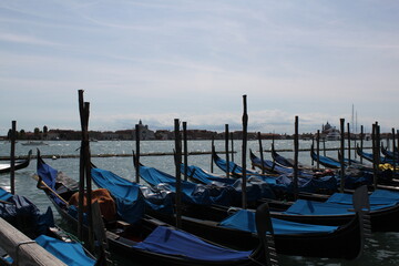 Fototapeta na wymiar Venetian motives of the gondola at the pier