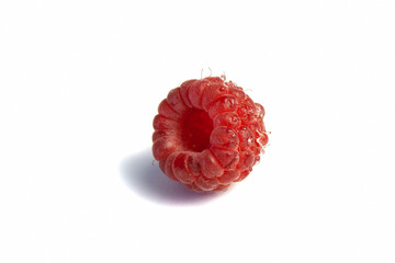 Ripe raspberry isolated on white background close-up. Fresh raspberries without sheets on a table with water droplets. Macro shooting. Healthy, wholesome food