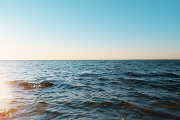 Naklejka premium Dark blue sea waves on the sunset