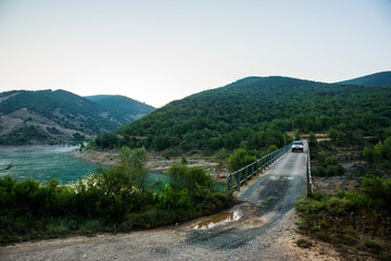 4x4 car crossing dangerous bridge in Aragon, Pyrenees, Spain