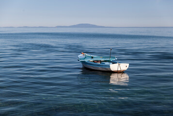 Fototapeta na wymiar Small fishing boat on the blue sea and blue sky,peaceful and lonely,Novalja,Pag,Croatia