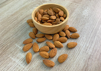 almond on wooden table with spoon, Almond in wooden bowl.