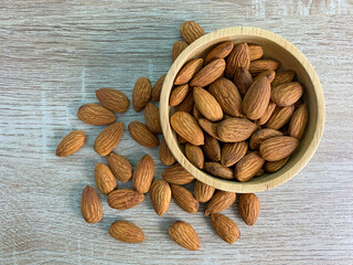 almond on wooden table with spoon, Almond in wooden bowl.