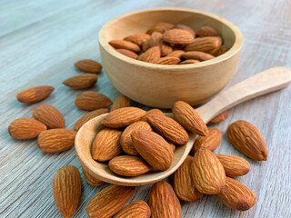almond on wooden table with spoon, Almond in wooden bowl.