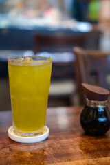 Iced green tea on wood table at Japan restaurant