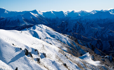 Winter landscape of snow mountain against blue sky in South island, New Zealand.