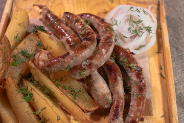 Delicious Provencal sausages with rustic potatoes and onions