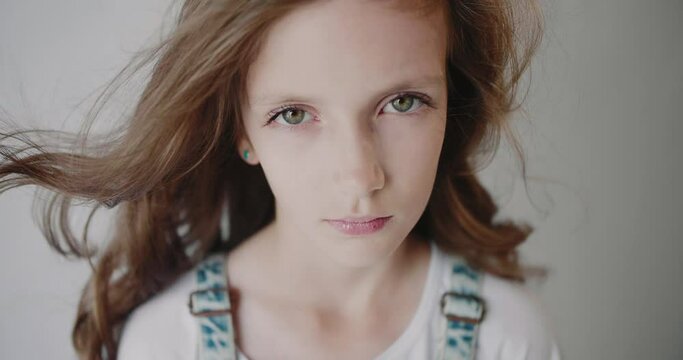 Portrait of a young caucasian girl 10 years old with loose hair. Isolated.